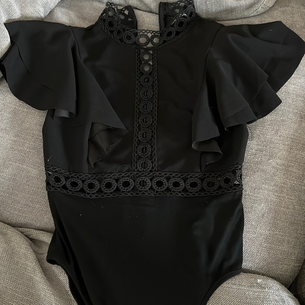 Black bodysuit with hole details.